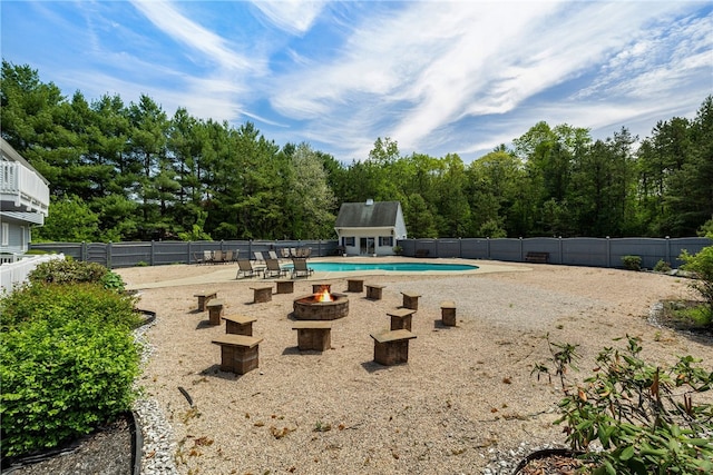 101 Nancy Ln, Burrillville, RI 02830 - view of pool with an outdoor fire pit, a fenced backyard, a patio area, an outdoor structure, and view of wooded area