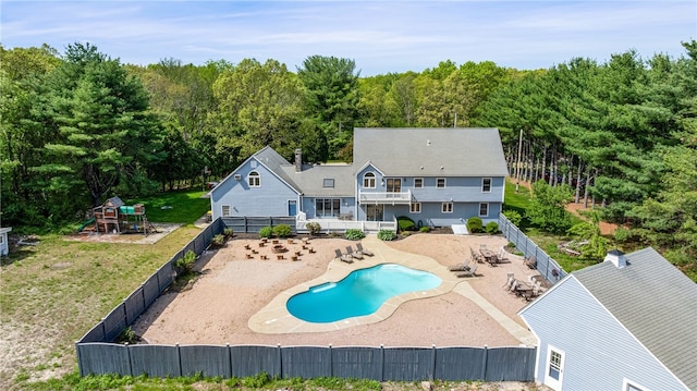 101 Nancy Ln, Burrillville, RI 02830 - back of property with a playground, a patio area, and a wooded view