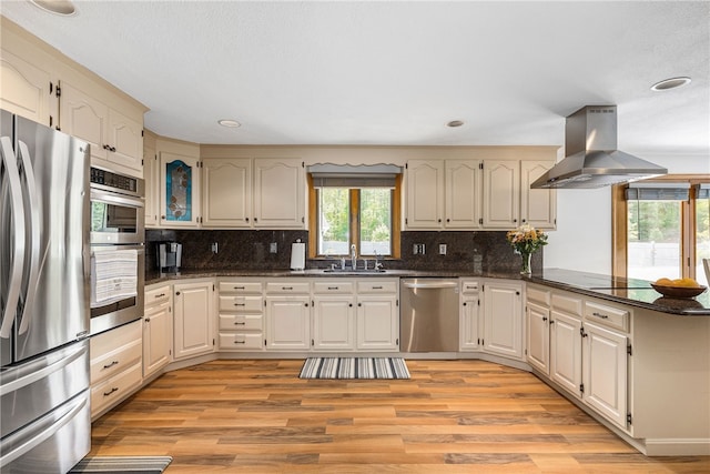 101 Nancy Ln, Burrillville, RI 02830 - kitchen with stainless steel appliances, island range hood, a peninsula, light wood finished floors, and recessed lighting
