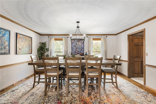101 Nancy Ln, Burrillville, RI 02830 - dining area with plenty of natural light, light wood-type flooring, a chandelier, ornamental molding, and baseboards