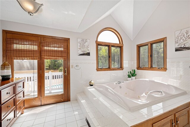 101 Nancy Ln, Burrillville, RI 02830 - bathroom with vaulted ceiling, tile patterned floors, a jetted tub, and wainscoting
