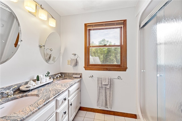 101 Nancy Ln, Burrillville, RI 02830 - bathroom featuring tile patterned flooring, double vanity, baseboards, and a shower with door
