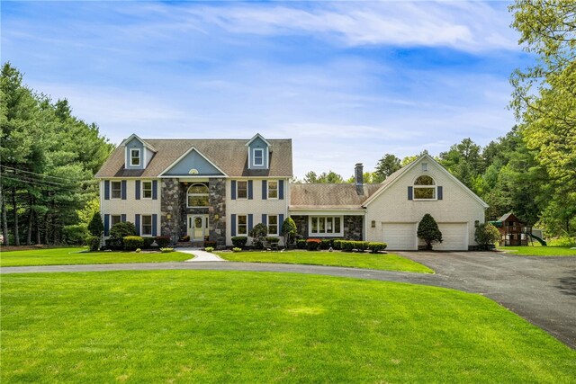 101 Nancy Ln, Burrillville, RI 02830 - view of front of house featuring a front lawn, stone siding, and driveway