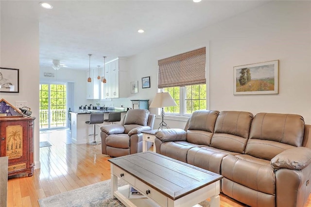 living room with healthy amount of natural light, recessed lighting, light wood-style floors, and a ceiling fan