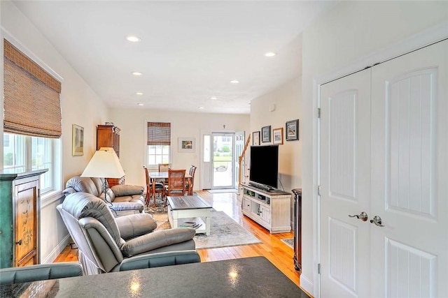 living room featuring light wood-type flooring, recessed lighting, and baseboards