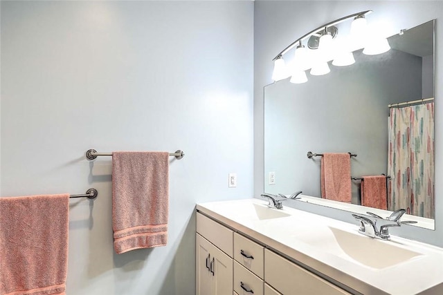 bathroom featuring double vanity and a shower with shower curtain