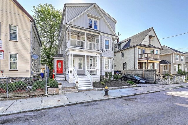 10 Westcott Ave Unit 1, Boston, MA 02124 - view of front facade featuring a balcony, fence, a porch, and board and batten siding