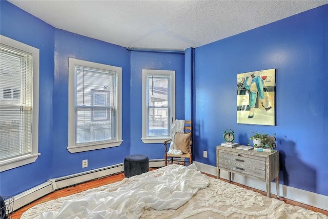 10 Westcott Ave Unit 1, Boston, MA 02124 - bedroom featuring a baseboard radiator, a textured ceiling, and baseboards