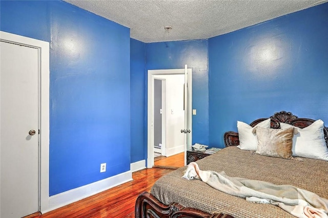 10 Westcott Ave Unit 1, Boston, MA 02124 - bedroom with wood finished floors, a textured ceiling, and baseboards
