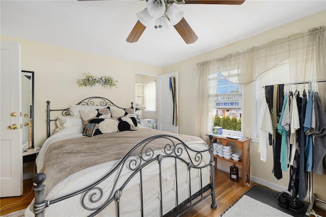 bedroom featuring wood finished floors and ceiling fan