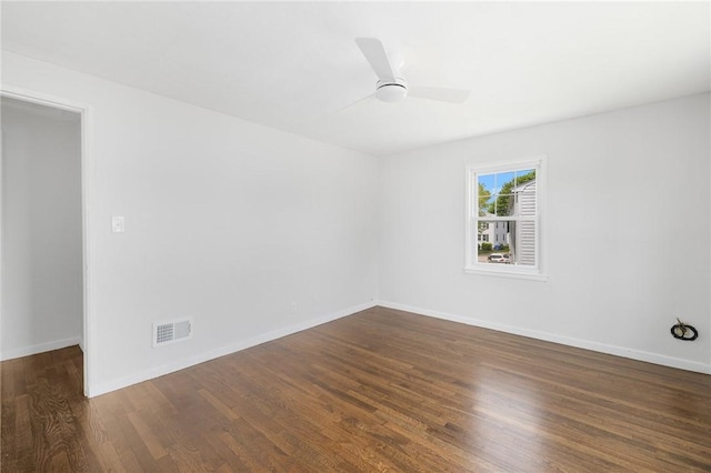 empty room with wood finished floors, baseboards, and ceiling fan
