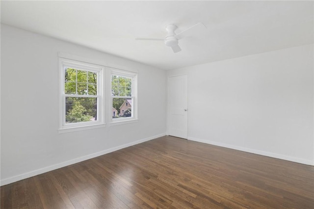 spare room with wood finished floors, baseboards, and ceiling fan