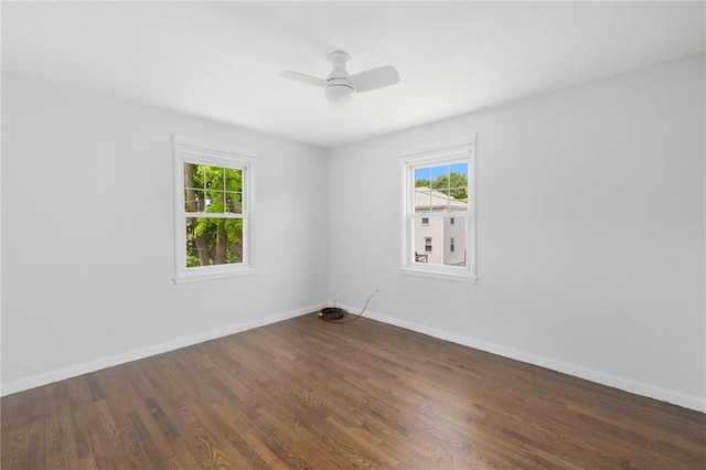 unfurnished room with wood finished floors, baseboards, and ceiling fan