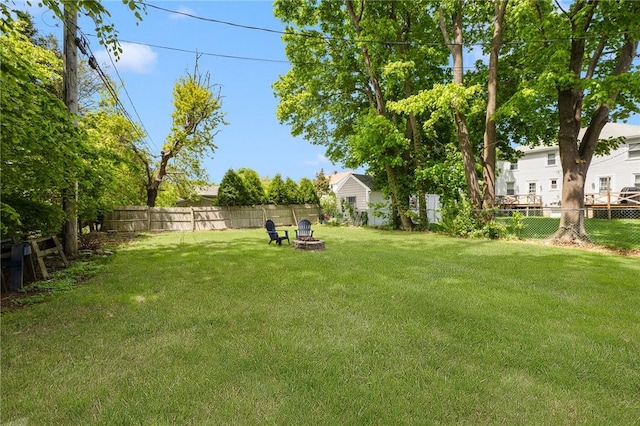 view of yard with an outdoor fire pit