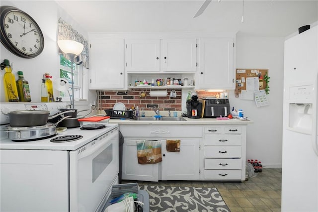 kitchen with white appliances, a sink, white cabinets, and light countertops