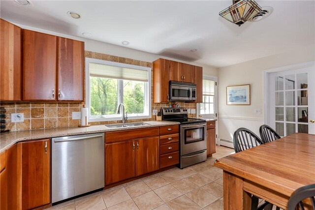 103 Carrs Pond Rd, West Greenwich, RI 02817 - kitchen with stainless steel appliances, a sink, healthy amount of natural light, tasteful backsplash, and recessed lighting