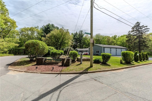 103 Carrs Pond Rd, West Greenwich, RI 02817 - view of front of property featuring a front lawn, a garage, asphalt driveway, and view of wooded area
