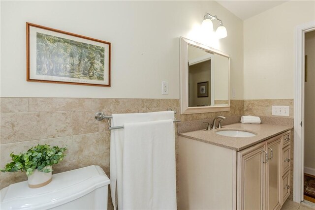 103 Carrs Pond Rd, West Greenwich, RI 02817 - bathroom with tile walls, vanity, a wainscoted wall, and toilet