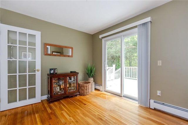 103 Carrs Pond Rd, West Greenwich, RI 02817 - doorway to outside featuring baseboard heating and light wood-style floors