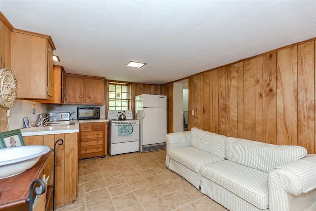 103 Carrs Pond Rd, West Greenwich, RI 02817 - kitchen featuring white appliances, brown cabinetry, light countertops, wood walls, and light tile patterned flooring