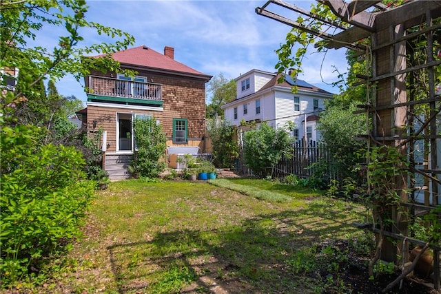 view of yard with a balcony