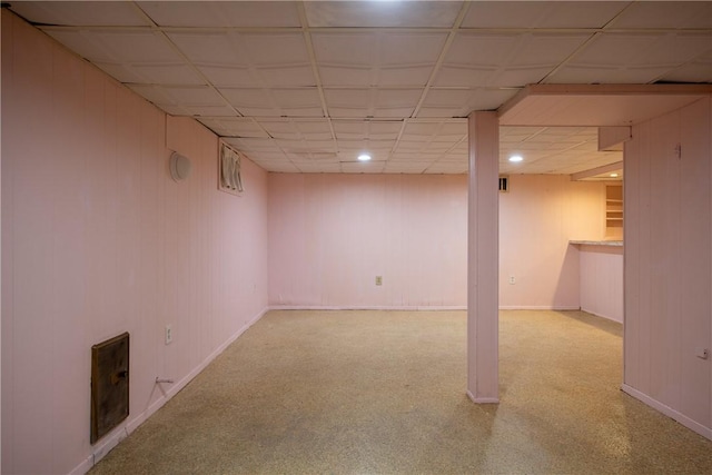 finished basement featuring carpet floors, a paneled ceiling, recessed lighting, and baseboards