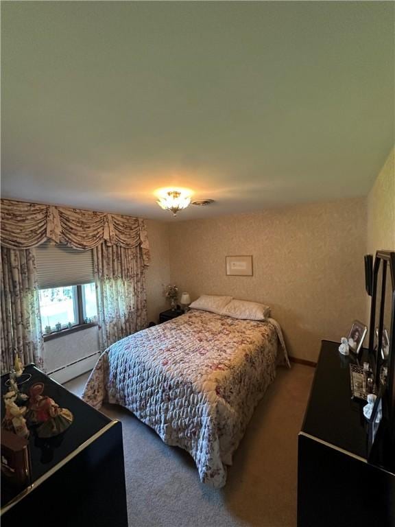 carpeted bedroom featuring a baseboard radiator