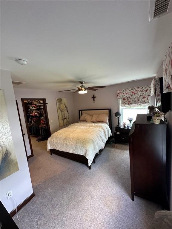 bedroom with carpet and a ceiling fan