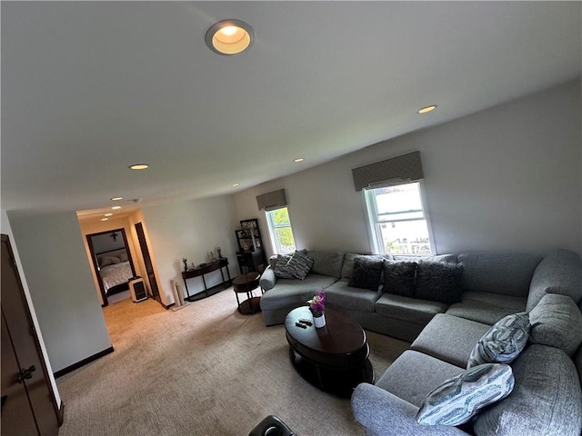 living area with light carpet and recessed lighting