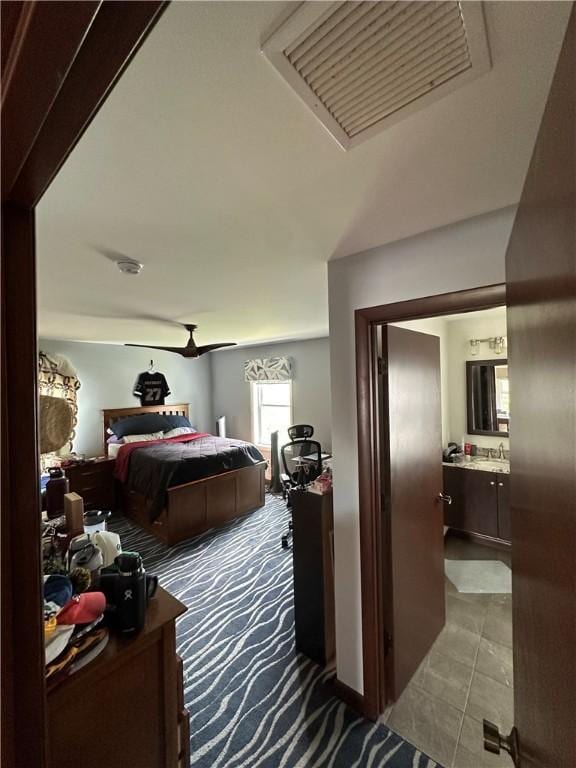 carpeted bedroom with a sink and connected bathroom