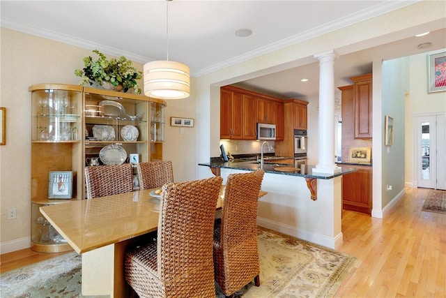 43 Waters Edge, Tiverton, RI 02878 - dining space featuring ornate columns, light wood finished floors, ornamental molding, and baseboards