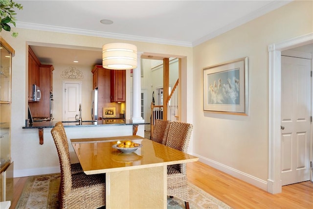 43 Waters Edge, Tiverton, RI 02878 - dining room featuring light wood-style floors, ornamental molding, baseboards, and stairs