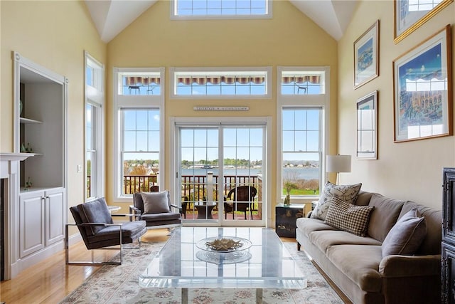 43 Waters Edge, Tiverton, RI 02878 - living area with wood finished floors, high vaulted ceiling, and a fireplace