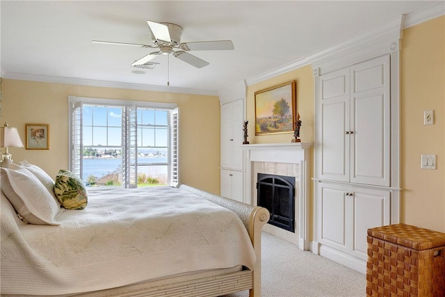 43 Waters Edge, Tiverton, RI 02878 - carpeted bedroom with ornamental molding, a fireplace, a ceiling fan, and a water view