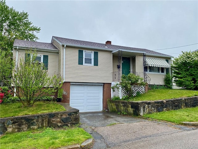 view of front of home featuring a chimney, asphalt driveway, and an attached garage