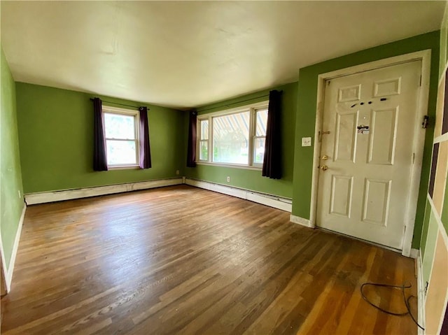 foyer with dark wood-type flooring, baseboards, and a baseboard radiator