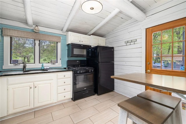 4 Ottawa Trl, Narragansett, RI 02882 - kitchen with black appliances, a sink, dark countertops, wooden walls, and white cabinetry