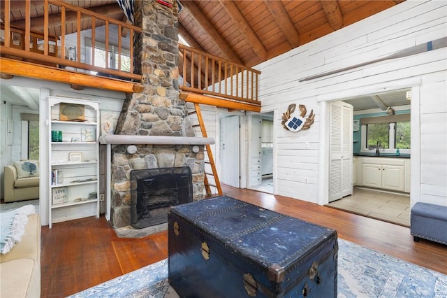 4 Ottawa Trl, Narragansett, RI 02882 - living room with wood-type flooring, wood ceiling, a fireplace, beam ceiling, and wooden walls