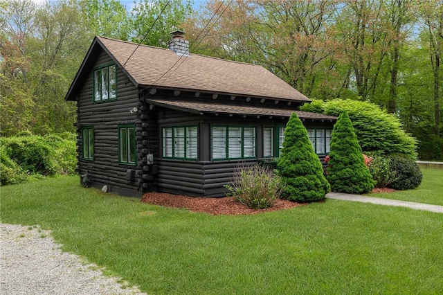 4 Ottawa Trl, Narragansett, RI 02882 - view of front of home featuring a chimney, a front lawn, log exterior, and roof with shingles