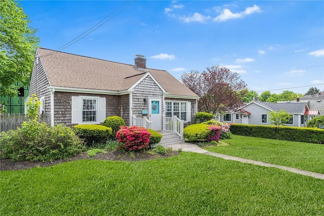 146 Bay View Ave, Bristol, RI 02809 - view of front of property featuring a chimney, roof with shingles, and a front lawn
