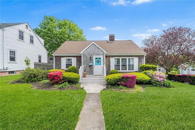 146 Bay View Ave, Bristol, RI 02809 - view of front of home with a chimney, a front yard, and a shingled roof