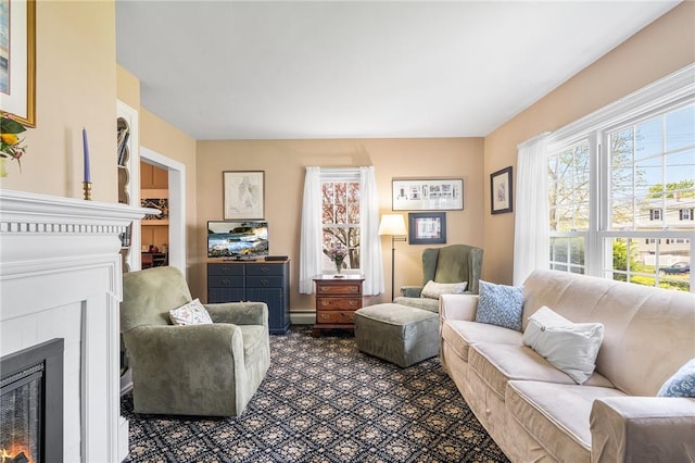 146 Bay View Ave, Bristol, RI 02809 - living area featuring a glass covered fireplace and a baseboard radiator
