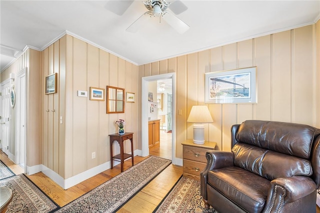 146 Bay View Ave, Bristol, RI 02809 - living area featuring light wood-type flooring, ornamental molding, a ceiling fan, and baseboards