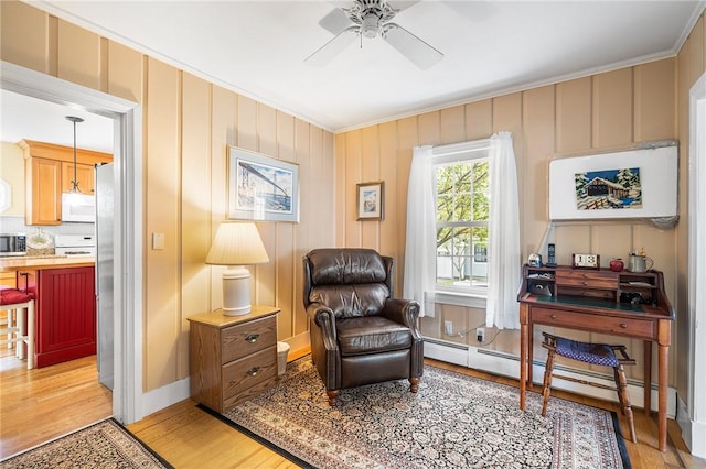 146 Bay View Ave, Bristol, RI 02809 - living area with crown molding, ceiling fan, baseboard heating, and light wood-style flooring