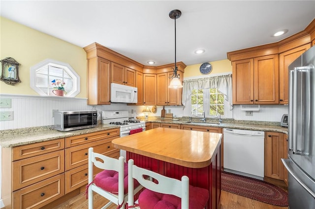 146 Bay View Ave, Bristol, RI 02809 - kitchen with appliances with stainless steel finishes, a sink, wainscoting, butcher block countertops, and pendant lighting