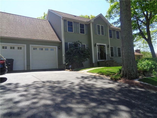 colonial home featuring an attached garage and driveway