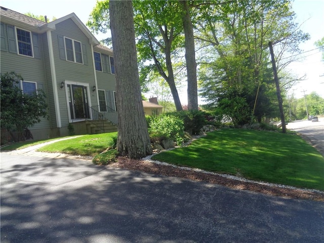 view of property exterior featuring a lawn