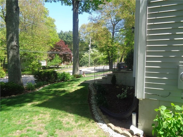 view of green lawn with stairs