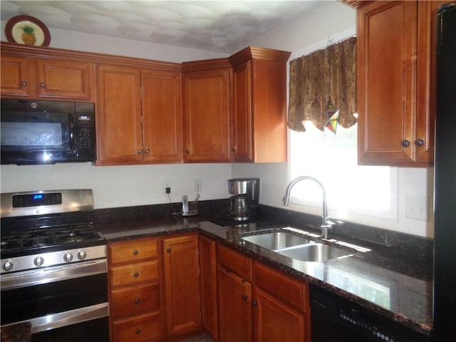 kitchen featuring black appliances, a sink, and brown cabinetry