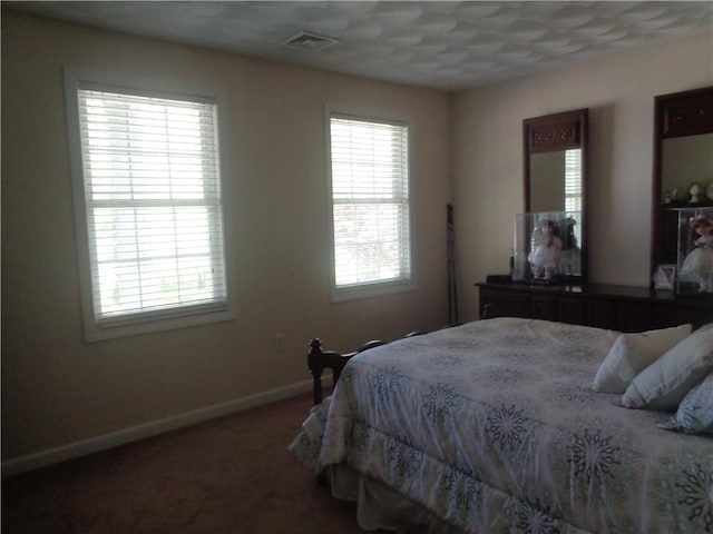 carpeted bedroom featuring baseboards